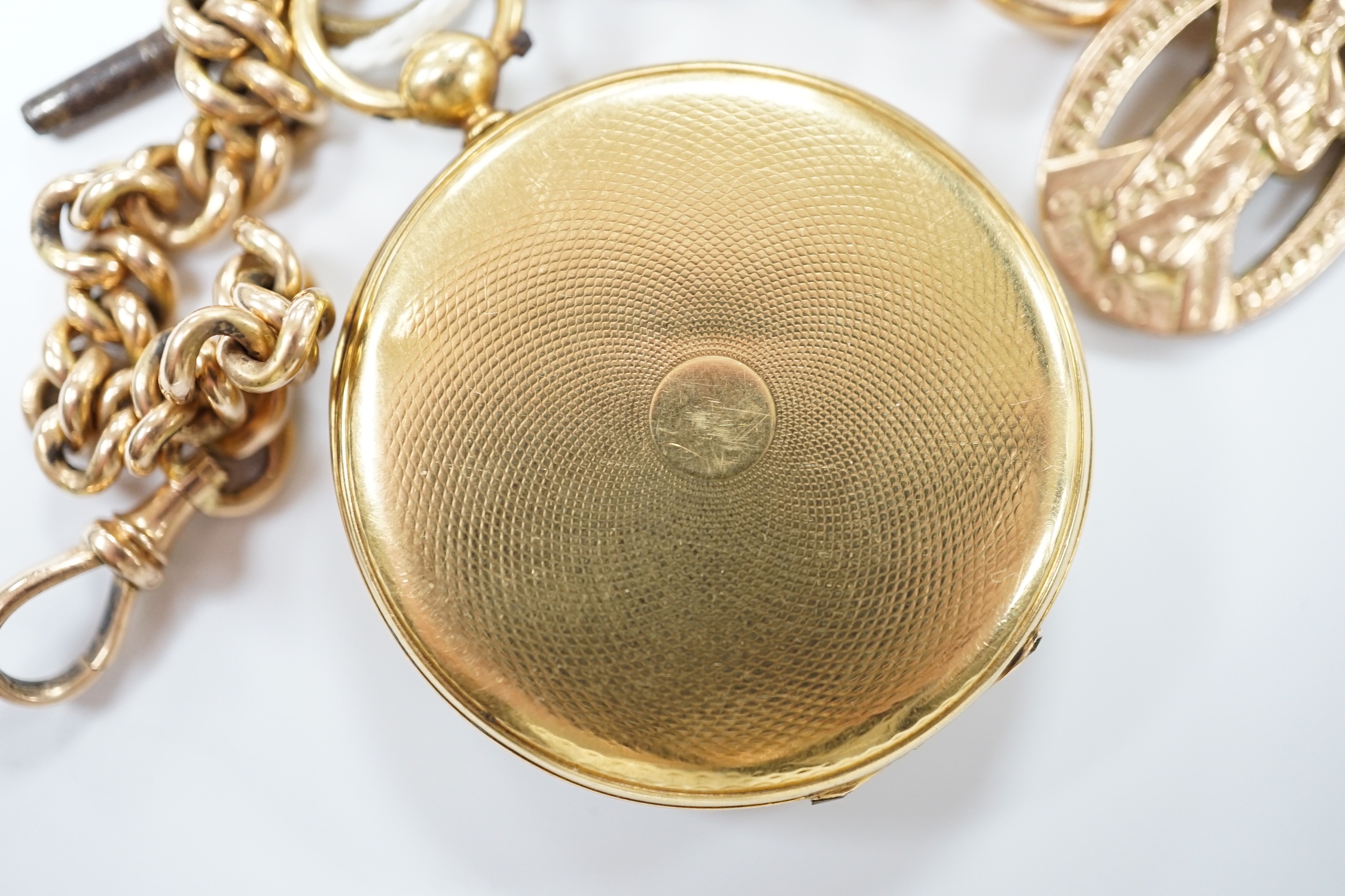 An 18k open face fob watch, with Roman dial, gross weight 38.5 grams, with key, together with a 9ct albert hung with a 9ct gold St. Andres Ambulance Association charm, gross weight 24.2 grams.